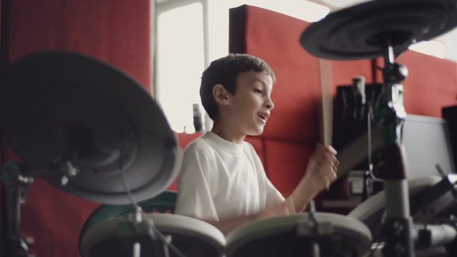 little boy playing electronic drums