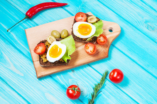 Sandwiches with olive, quail eggs, cherry tomatoes and potatoes