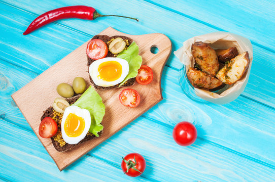 Sandwiches with olive, quail eggs, cherry tomatoes and potatoes