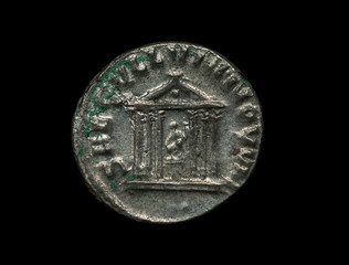 Ancient silver roman coin with image of a temple isolated on black