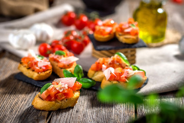 Tasty bruschetta with tomato,  basil, parmesan, olive oil ...