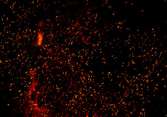 Fototapeta na wymiar fire flames with sparks on a black background