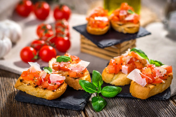 Tasty bruschetta with tomato,  basil, parmesan, olive oil ...