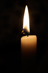 A candle flame on a dark background