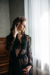 Fototapeta premium slender young bride in a beautiful black lingerie