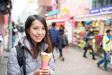 Young woman enjoy her crepe cake at outdoor