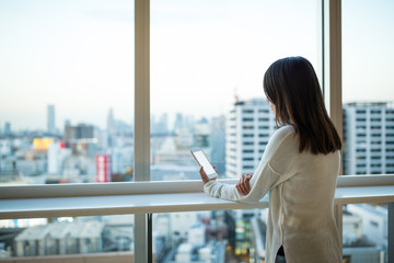 Woman using cellphone inside office