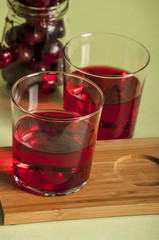 glass of fresh cherry juice and fresh cherries