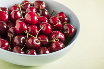 Red cherries in antique bowl