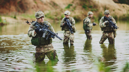special forces soldiers with weapon take part in military maneuv - obrazy, fototapety, plakaty