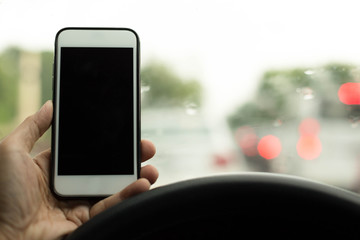 Safty concept Man driving using cell phone while raining
