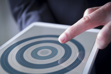 Fototapeta na wymiar finger touches digital tablet target