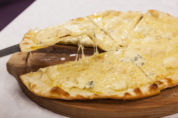 Hand shovel takes a slice of pizza