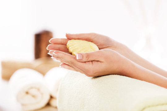 Well Manicured Nails. Holding a Soap. Close up Spa Concept.