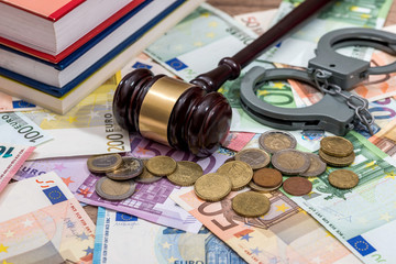 handcuffs with hammer of judge and euro. business concept