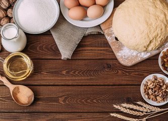 Top view Baking ingredients for homemade pastry on dark rustic wood background