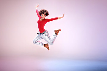 Fototapeta na wymiar Young girl with afro dancing.