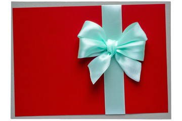 Turquoise bow and ribbon on red