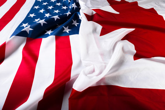 American and Canadian flags together