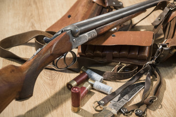double-barreled shotgun, bullets, knife and cartridge belt