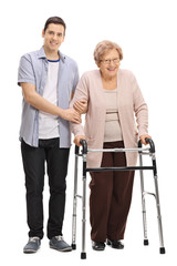 Young man helping a mature woman with a walker