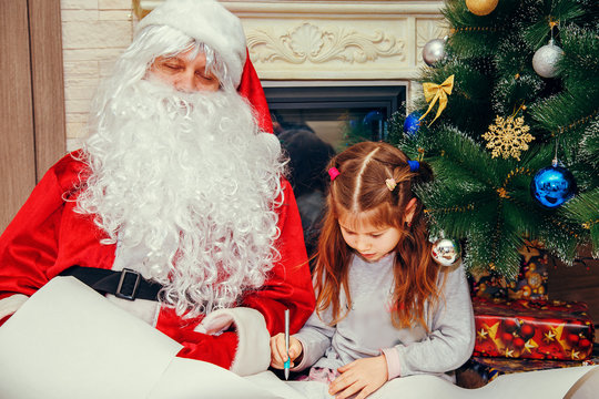 Little girl writes a letter to Santa.