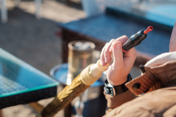 man smoking shisha outdoor