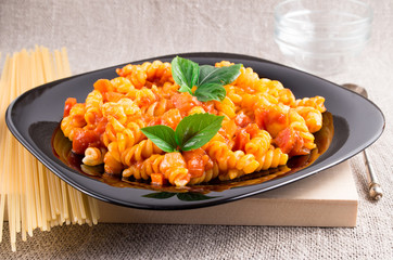 Cooked pasta girandole on a wooden tray