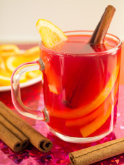Mulled wine, cinnamon and orange to bright shiny background