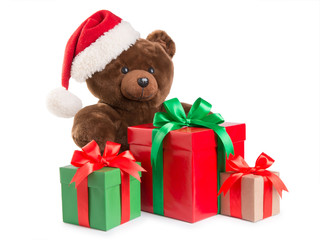 teddy bear in a santa hat and gifts isolated on white