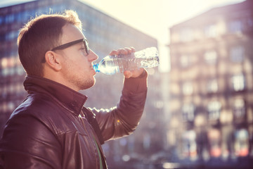 Man drinking water in the city