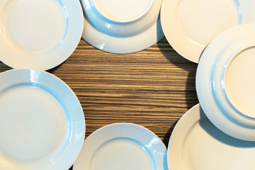 Empty white plates on wooden table