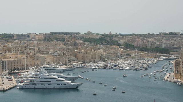 VALLETTA, MALTA - July 1st 2016: view over the bay of Grand Harbour from the Upper Baraka Gardens on war museum to the older UNESCO protected historic skyline of Senglea, Birgu and Kalkara.