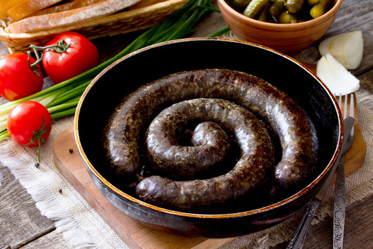 Homemade liver sausage and a variety of vegetables, herbs on rus
