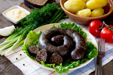 Homemade buckwheat liverwurst and sausage and boiled potatoes on