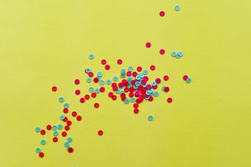 Red and green buttons on yellow paper