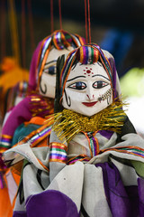 Hand made puppets attached to string in Rajasthan India dolls. Women face with traditional Indian...
