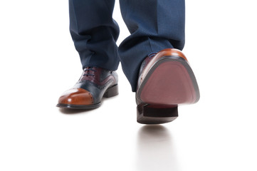 Close-up of man shoes and trousers in walking position