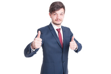 Smiling man in suit showing thumbs up