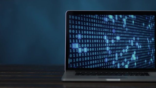 laptop with blue colored digital binary code