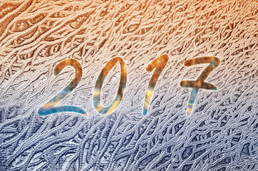 New year 2017 written on a frozen glass