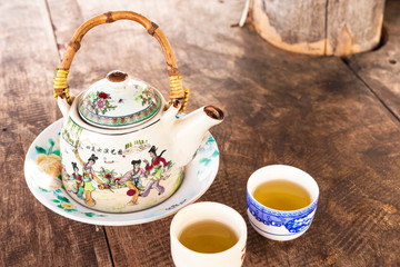 Chinese style teacup and teapot with green tea