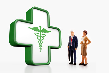 miniature people  - Elderly couple standing in front of a pharmacy sign