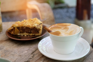 Coffee latte and apple pie on wooden.