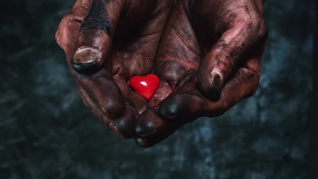 4k Technical Composition of Dirty Mechanic Hands Holding Heart