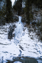 Huge icicles formed in a waterfall on a mountain