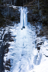 Huge icicles formed in a waterfall on a mountain