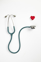 Red heart and stethoscope isolated on white background