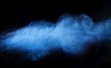 Blue powder cosmetics against black background
