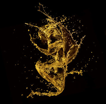 Yellow serum splashing against black background
